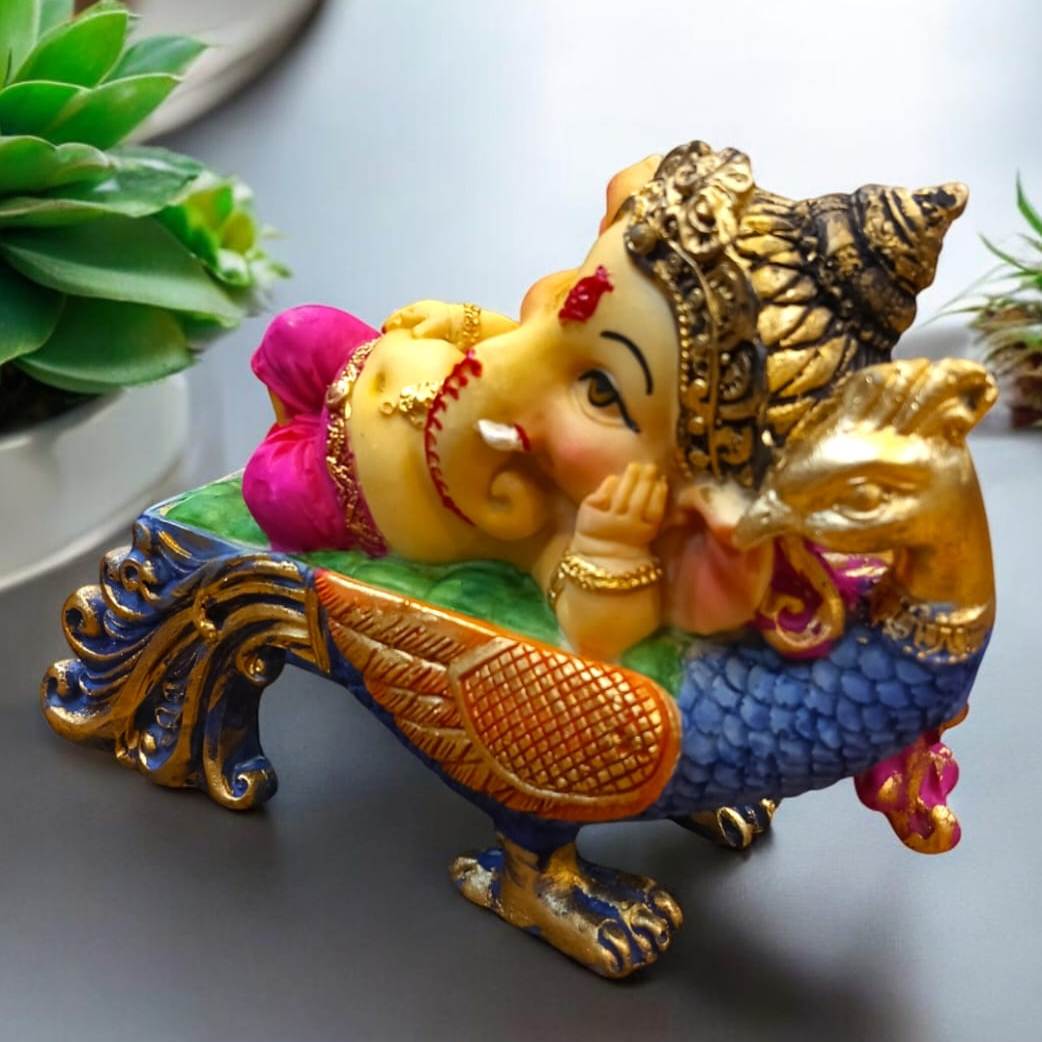 Multicolor Ganesha Lying on Peacock Resin Statue | EnamorarDecor